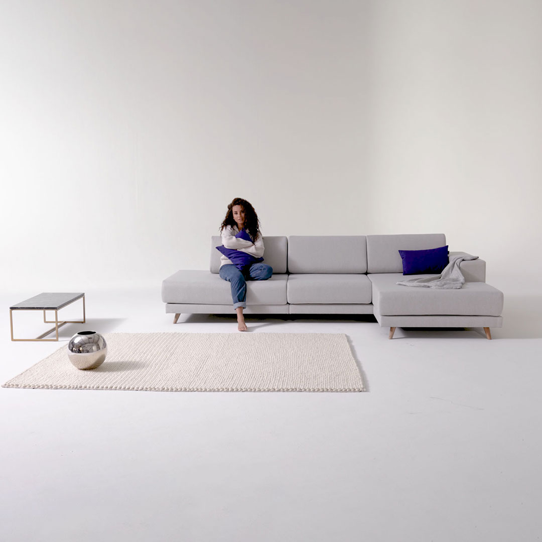 corner sofa grey FLAYR with woman and couch table with marble tabletop