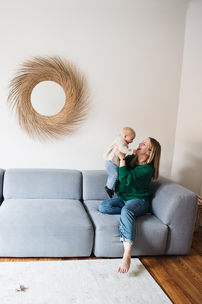Alexa with baby on blue sofa PYLLOW